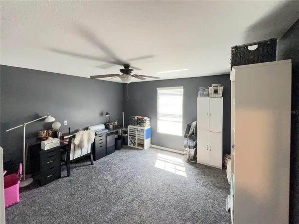 a view of a livingroom with furniture and a window