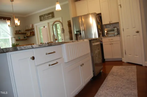 a kitchen with refrigerator a microwave and cabinets