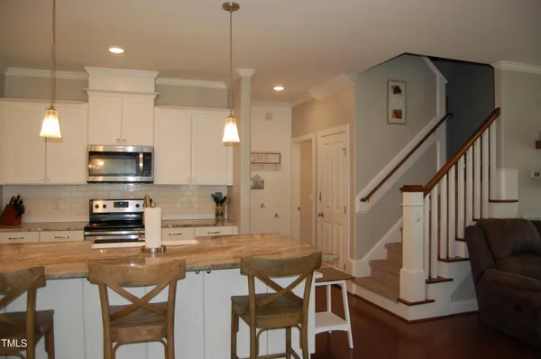 a kitchen with stainless steel appliances kitchen island granite countertop a sink and cabinets