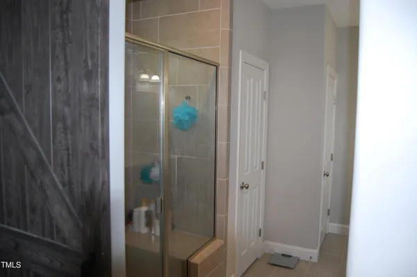 a bathroom with a shower and mirror
