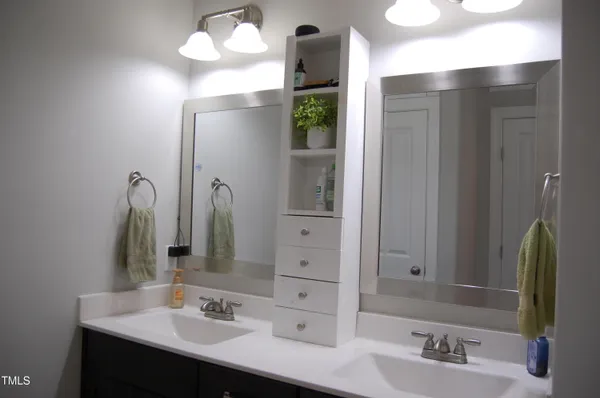 a bathroom with a sink vanity and a mirror