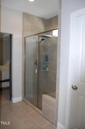 a bathroom with a glass shower door