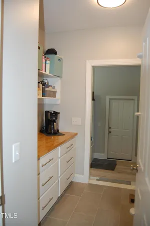 a hallway with cabinets and window