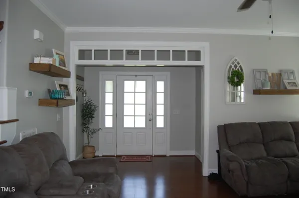 a living room with furniture and wooden floor