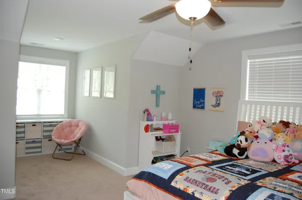 a bedroom with a bed and a dresser in it