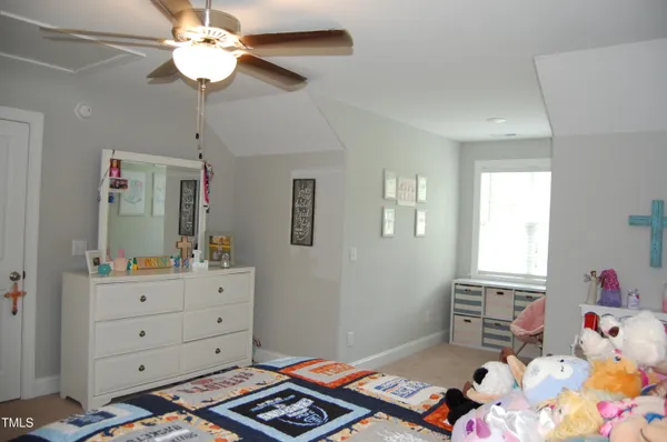 a bedroom with furniture and a window
