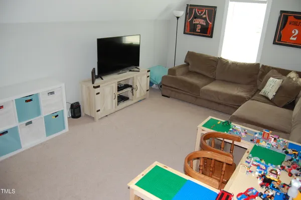 a room with furniture and flat screen tv