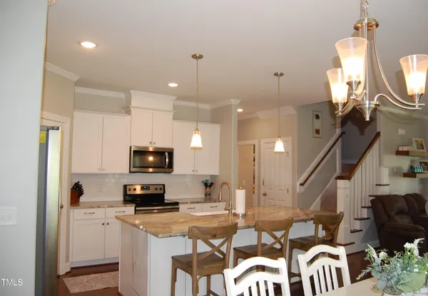 a kitchen with a sink appliances and cabinets