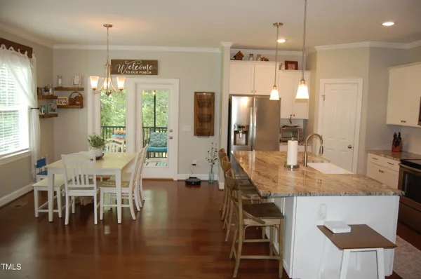 a view of a dining room with furniture and wooden floor