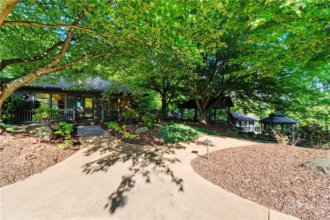 39 Raptor Way Landrum, SC 29356 - Photo 12 of 50 This charming home features a private entrance, nestled amongst lush greenery and mature trees.