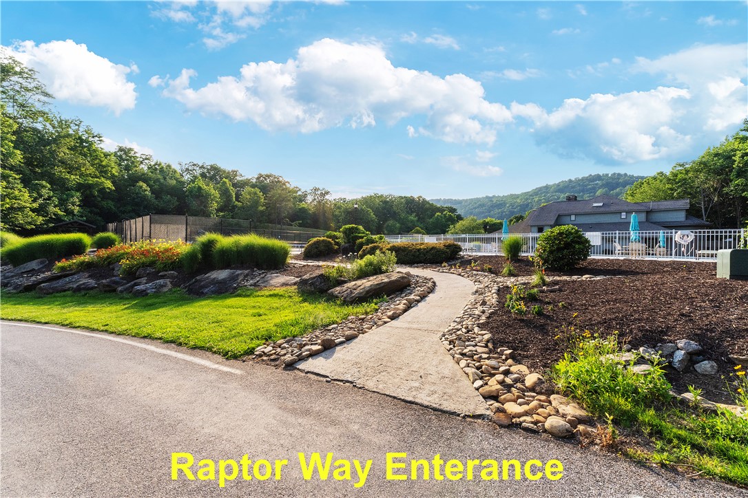 39 Raptor Way Landrum, SC 29356 - Photo 25 of 50 A winding path leads to a refreshing community pool, surrounded by verdant landscapes and distant hills.