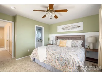 a bedroom with a bed and a painting on the wall