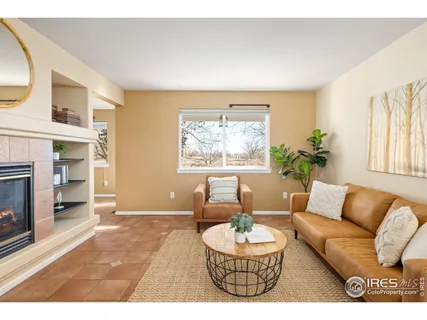 a living room with furniture a fireplace and a table