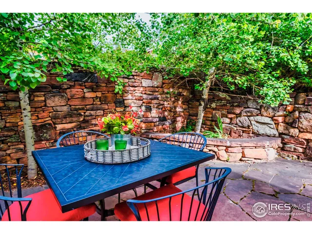 a view of a patio with a dining table and chairs with a fire pit and a yard