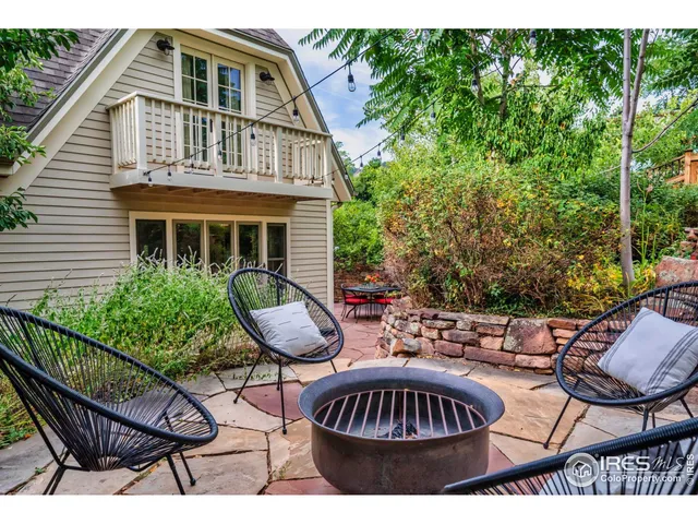 a bedroom with a bed a mirror and lamp