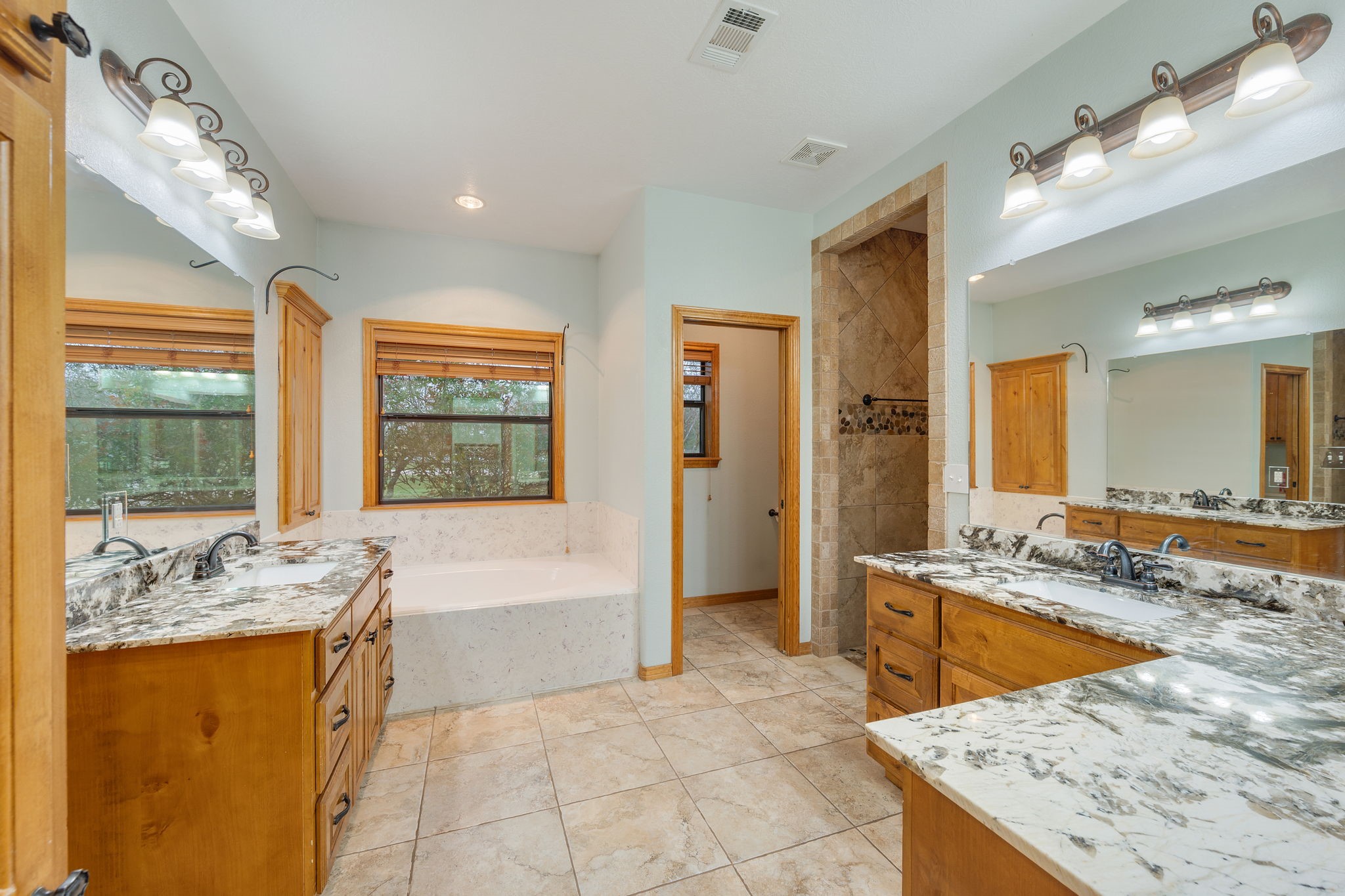 7754 Edge Cut Off Road Hearne, TX 77859 - Photo 15 of 50 a bathroom with a granite countertop tub sink and mirror