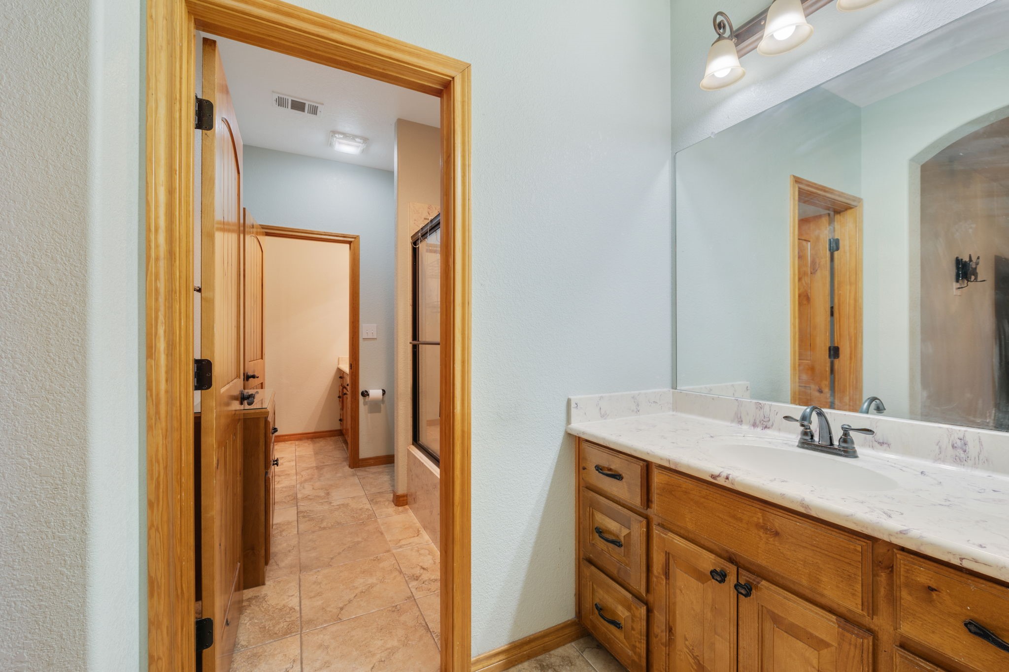 7754 Edge Cut Off Road Hearne, TX 77859 - Photo 23 of 50 a en suite bathroom with a sink double vanity and a mirror