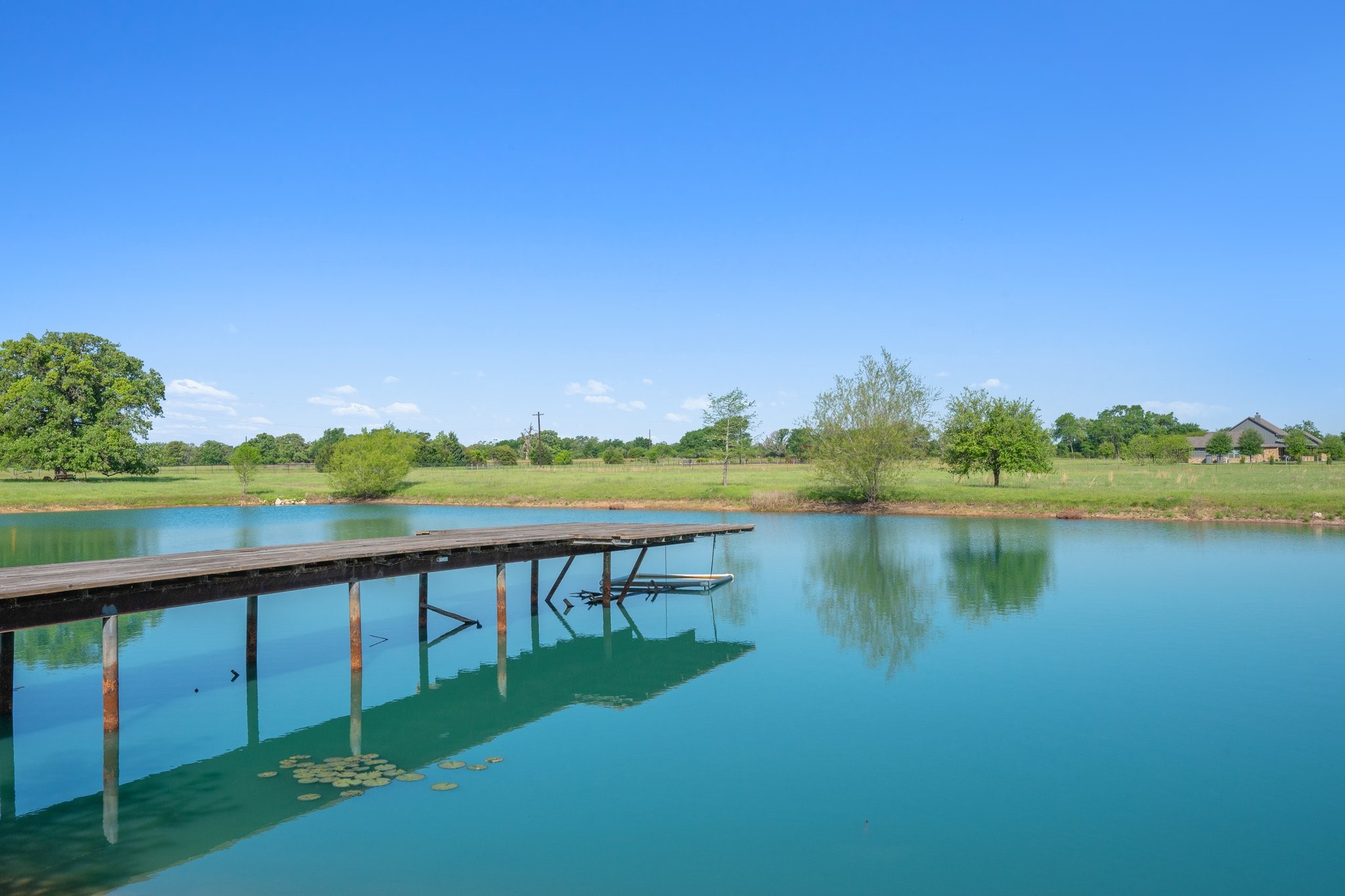 7754 Edge Cut Off Road Hearne, TX 77859 - Photo 28 of 50 a view of a lake with houses in the back