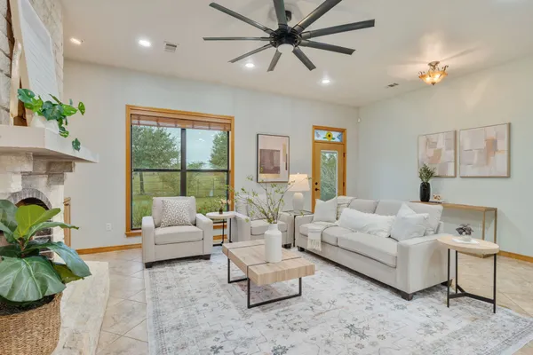 a living room with furniture and a large window
