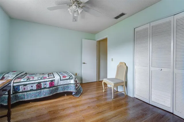 a bed room with a bed and a chair