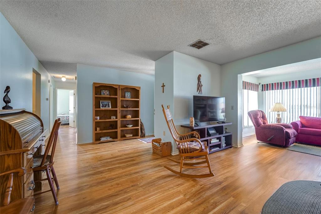 8360 High Point Circle, Unit 3 Port Richey, FL 34668 - Photo 5 of 15 a living room with furniture and a flat screen tv