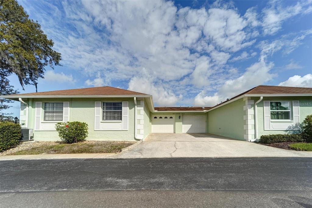 8360 High Point Circle, Unit 3 Port Richey, FL 34668 - Photo 6 of 15 a front view of a house with garage