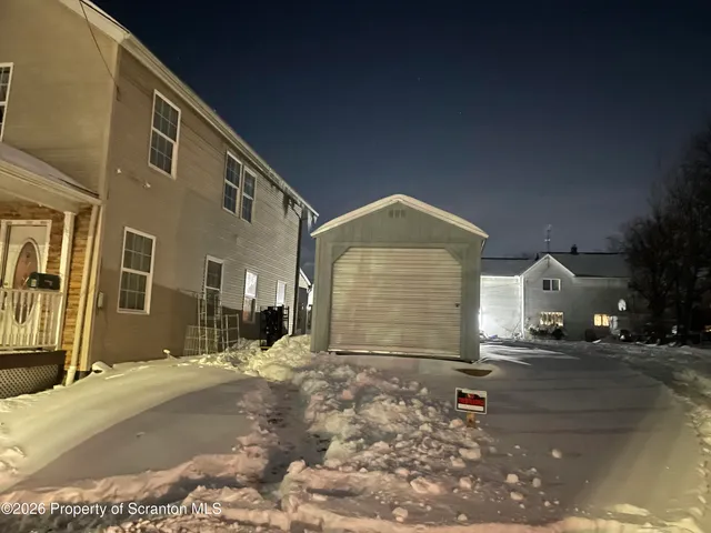a view of a house with a snow on the road
