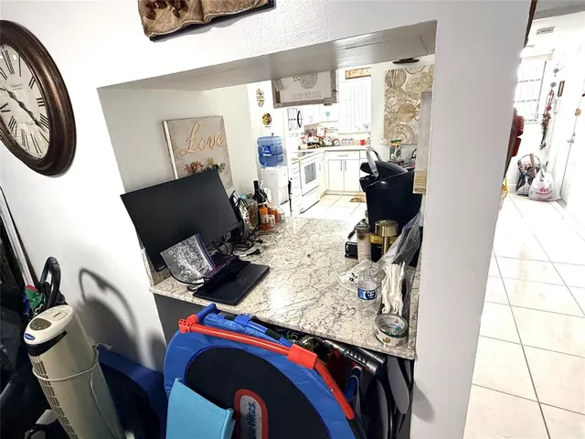 a living room with furniture a flat screen tv and a window