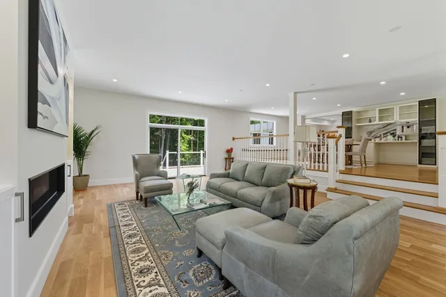 a living room with furniture wooden floor and a fireplace