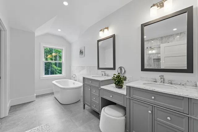 a bath room with a toilet a sink and a mirror