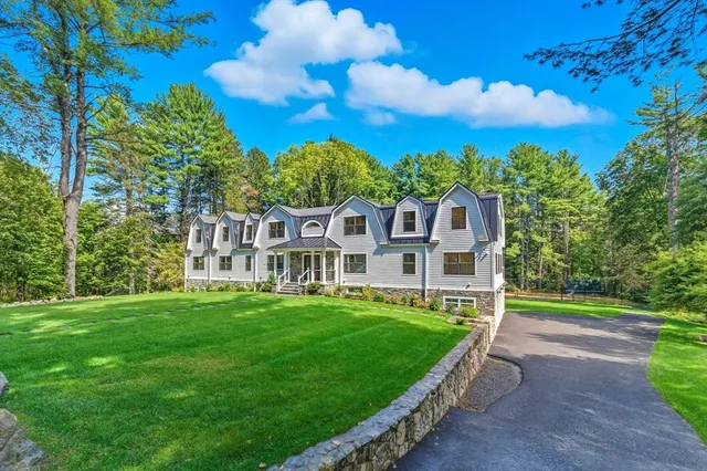 a front view of a house with a yard table and chairs