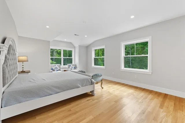 a bedroom with a large bed and a window