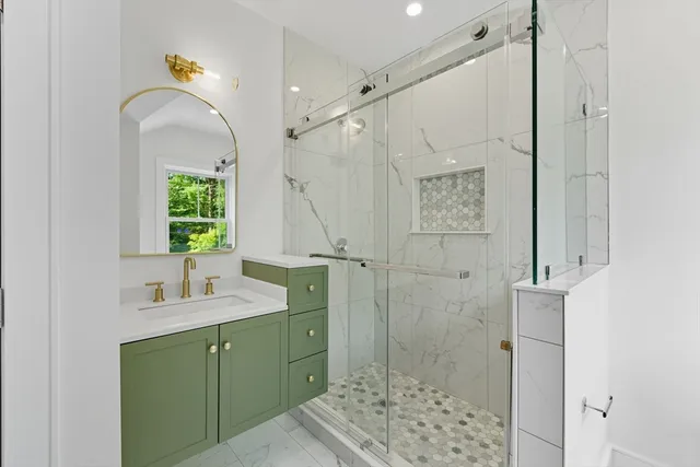 a bathroom with a double vanity sink mirror and shower