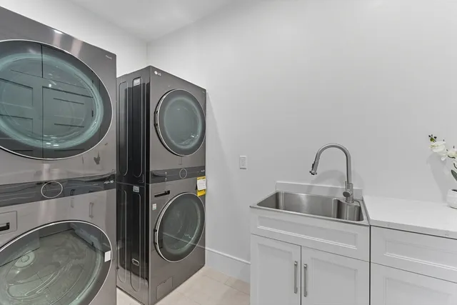 a utility room with sink dryer and washer