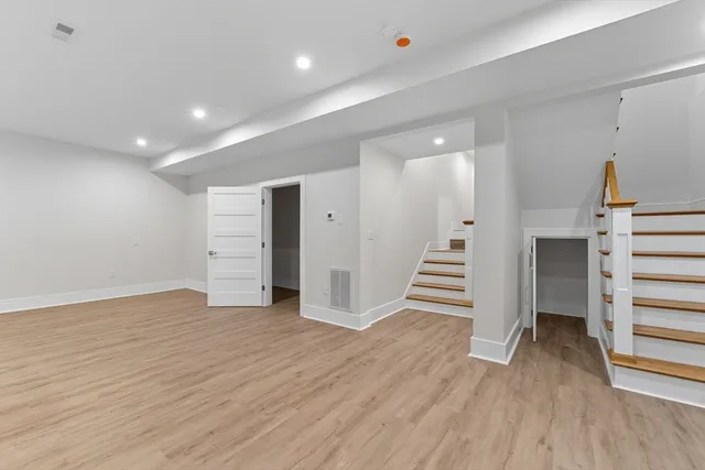 a view of a room with wooden floor and stairs