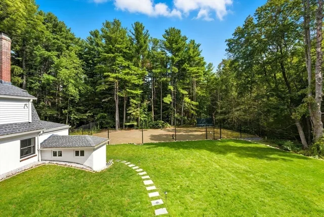 a swimming pool with lots of trees and plants