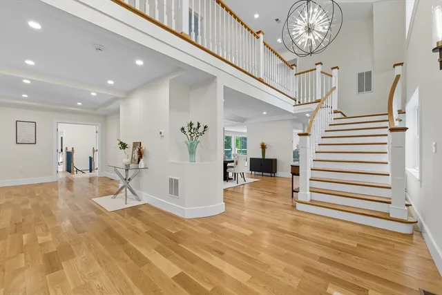 a view of entryway and hall with wooden floor
