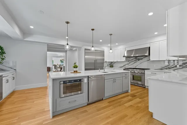 a kitchen with a stove sink and cabinets
