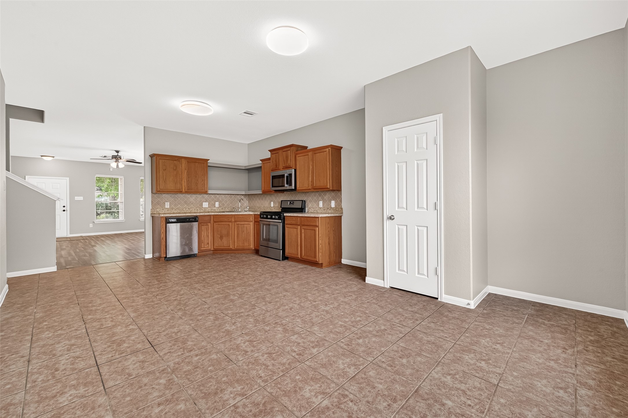 21327 Bella Flora Court Spring, TX 77379 - Photo 11 of 50 a view of a kitchen with a sink a refrigerator a microwave and a sink