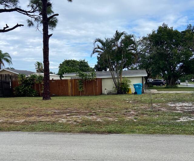 702 Northwest 8th Court Boynton Beach, FL 33426 - Photo 2 of 10 a big house with a yard and large trees
