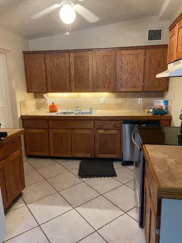 a kitchen with a sink and cabinets