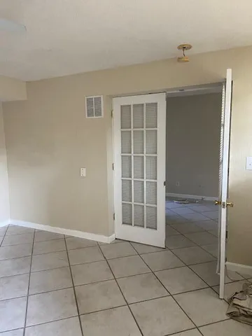 en empty room with fan and window