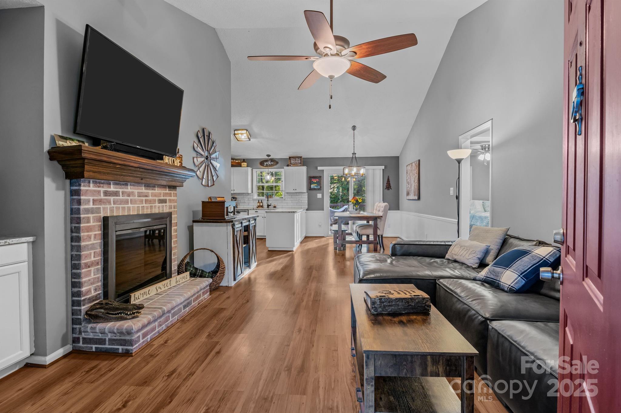 7229 Catawba Springs Road Denver, NC 28037 - Photo 11 of 48 a living room with furniture a flat screen tv and a fireplace