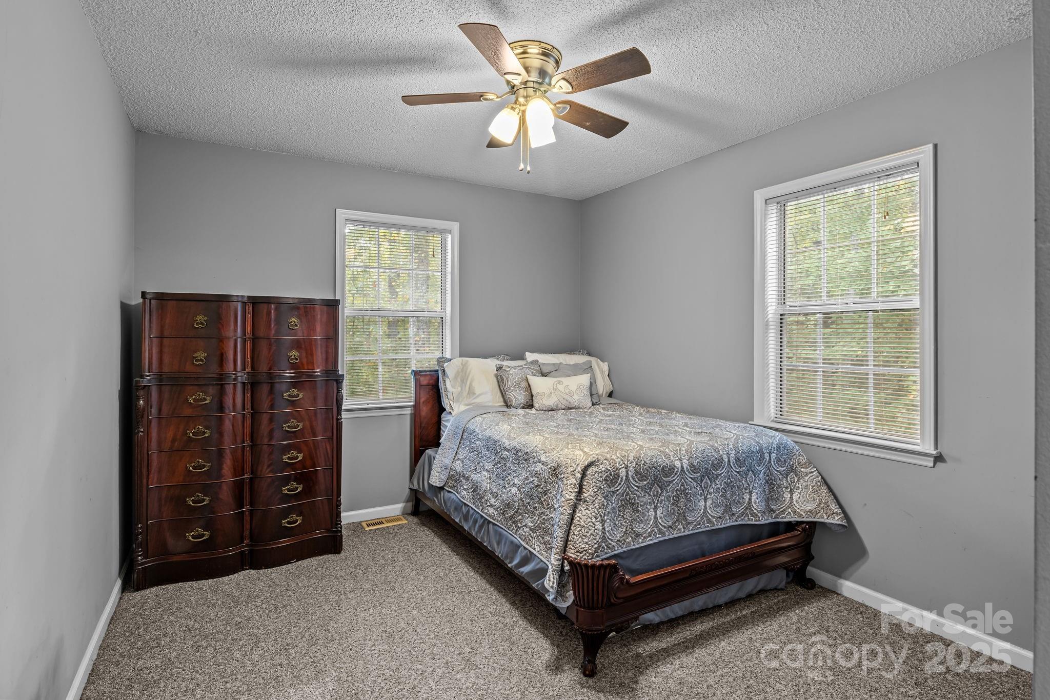 7229 Catawba Springs Road Denver, NC 28037 - Photo 31 of 48 a bed sitting in a bedroom next to a window