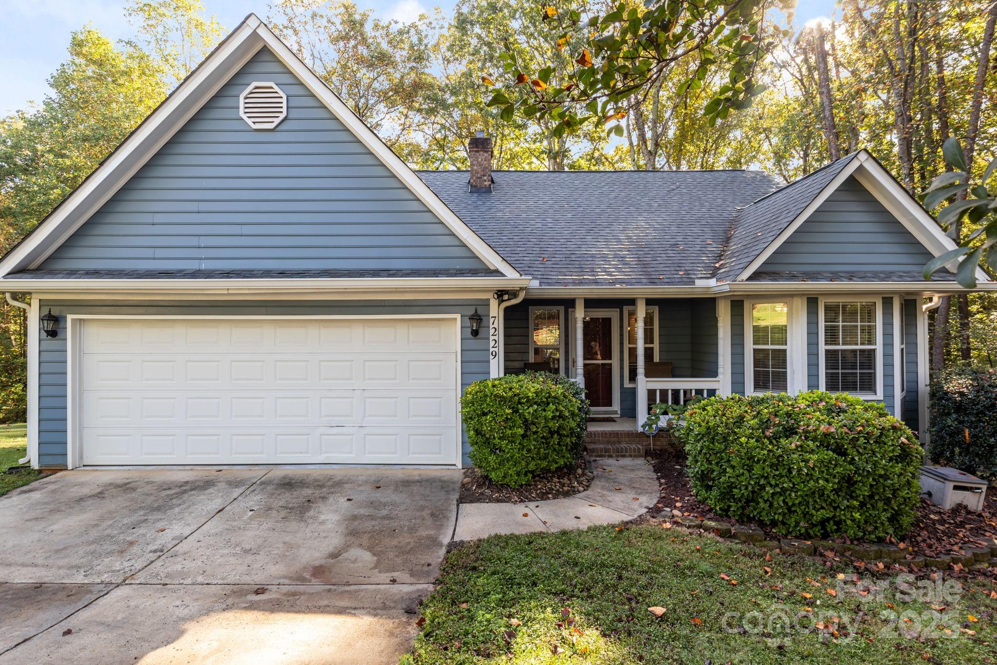 7229 Catawba Springs Road Denver, NC 28037 - Photo 7 of 48 a front view of a house with garden