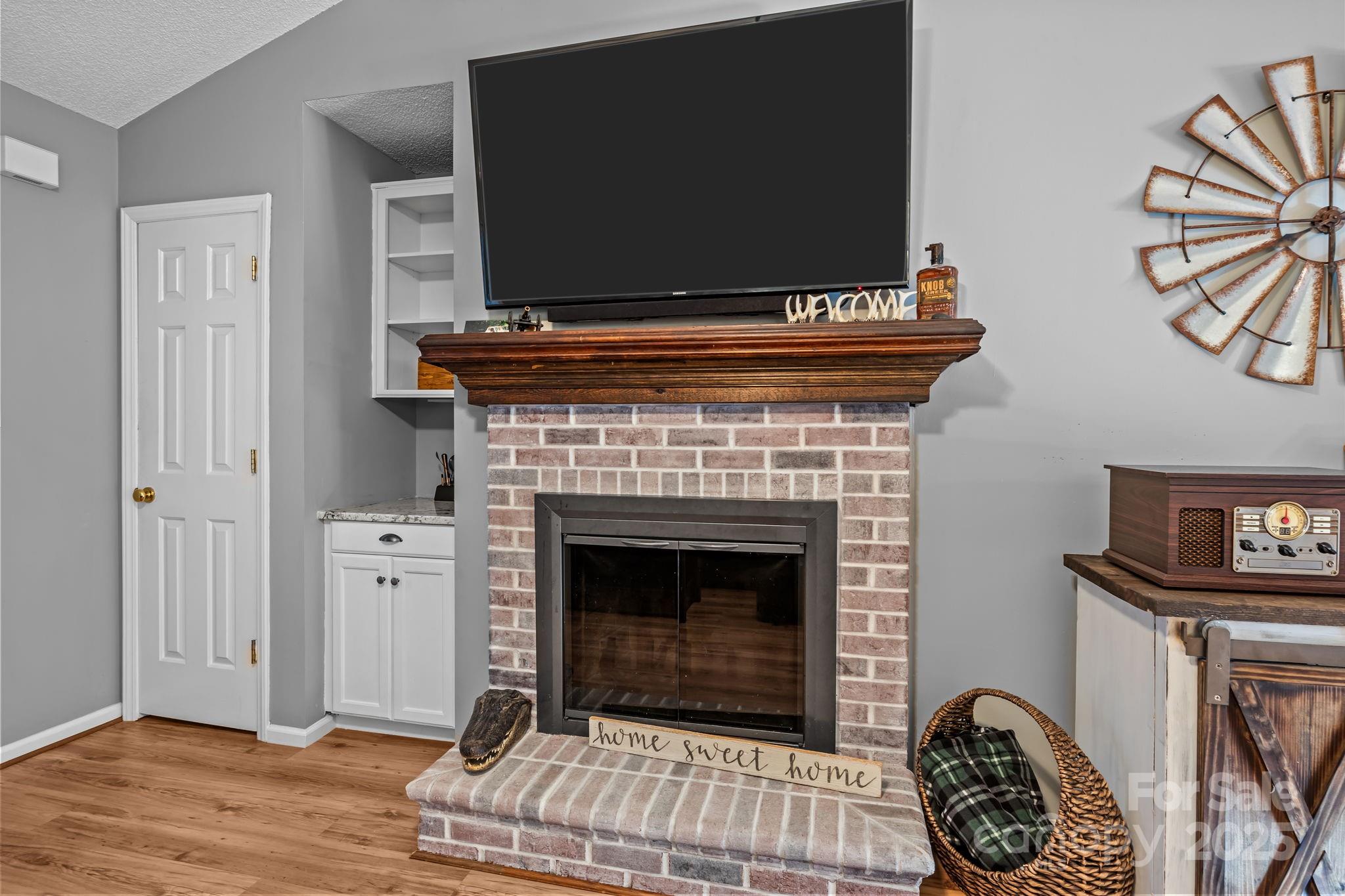 7229 Catawba Springs Road Denver, NC 28037 - Photo 9 of 48 a living room with furniture a flat screen tv and a fireplace