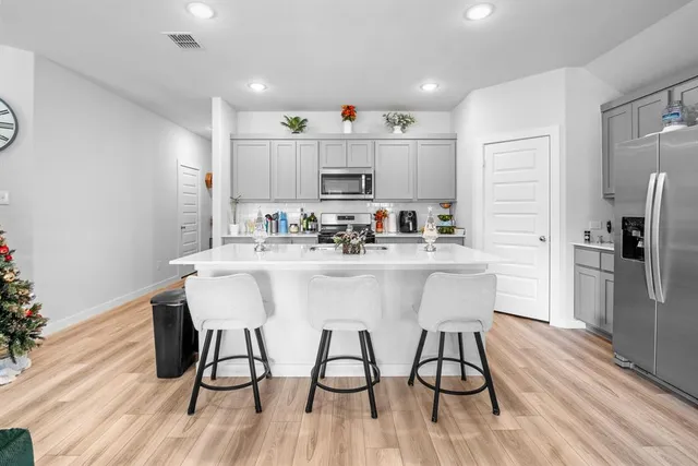 a kitchen with stainless steel appliances granite countertop a sink and cabinets
