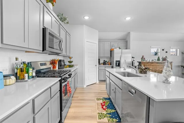 a kitchen with stainless steel appliances granite countertop a sink and stove