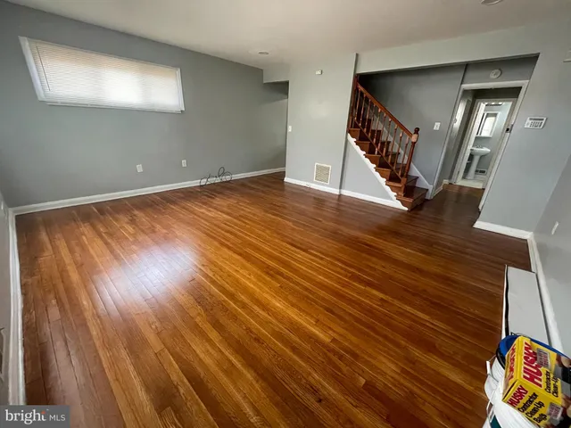 wooden floor in an empty room with a window