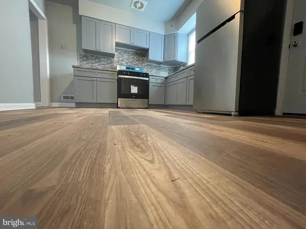 a kitchen with granite countertop a stove and a microwave